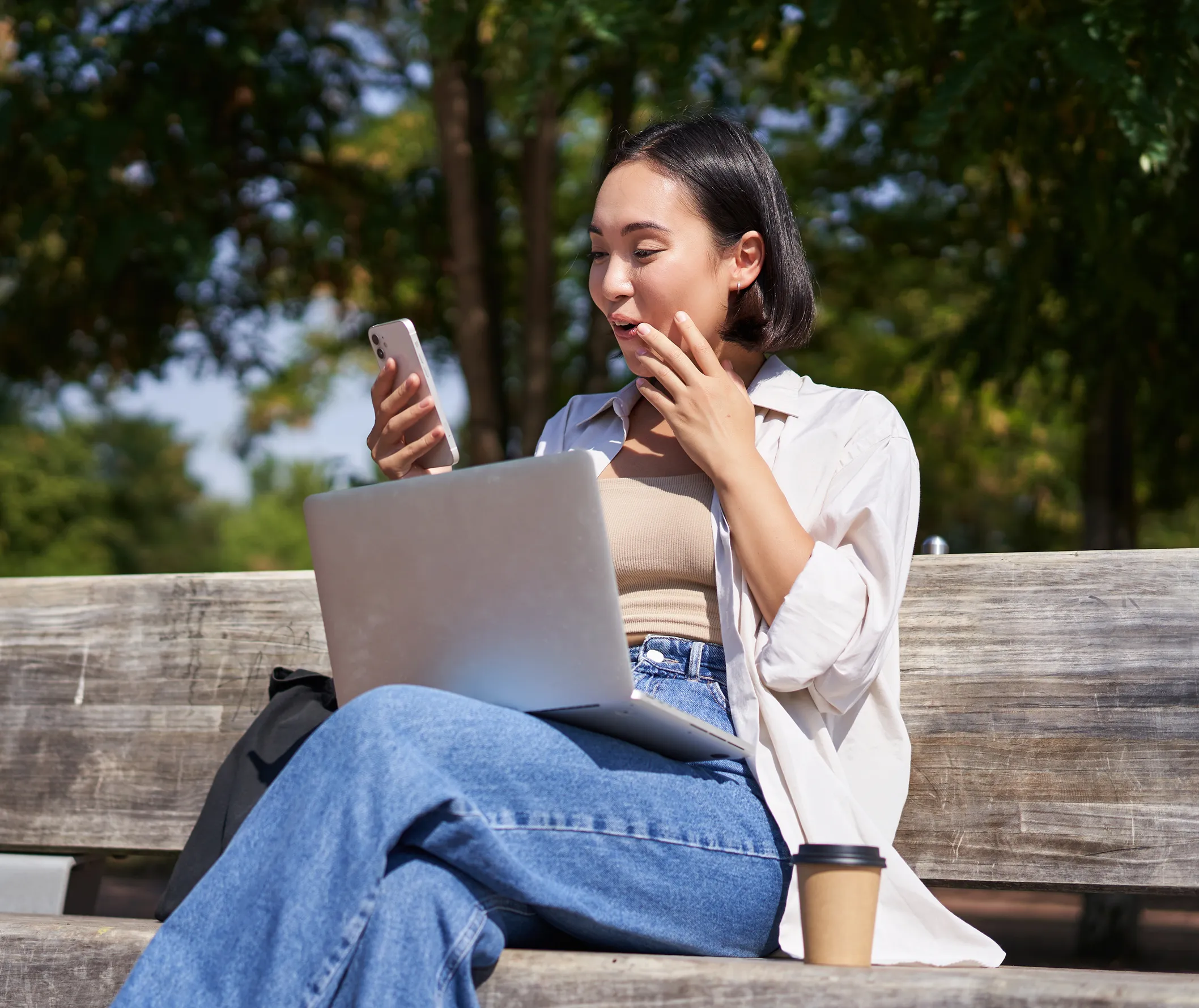 Startup founder looks at her phone as her new app has been deployed on the app store